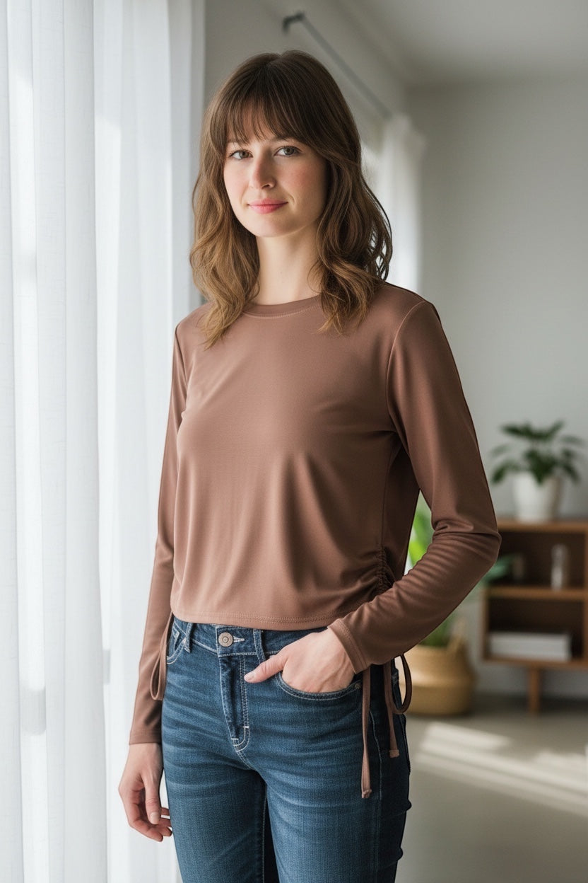 JJACollection brown long sleeve ruched drawstring top on a woman wearing blue jeans.
